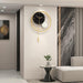 Modern wall clock in a stylish living room setting with a sofa and decorative elements.