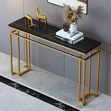 Console table with gold frame and black marble top in a room setting