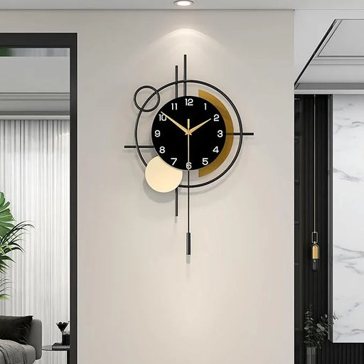 Modern wall clock with long pendulum on a light gray wall