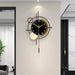 Modern wall clock with long pendulum on a light gray wall