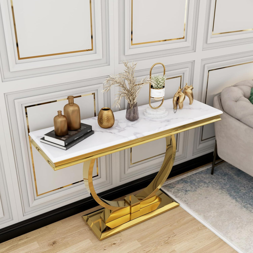Decorative console table with gold legs and marble top in a stylish room.