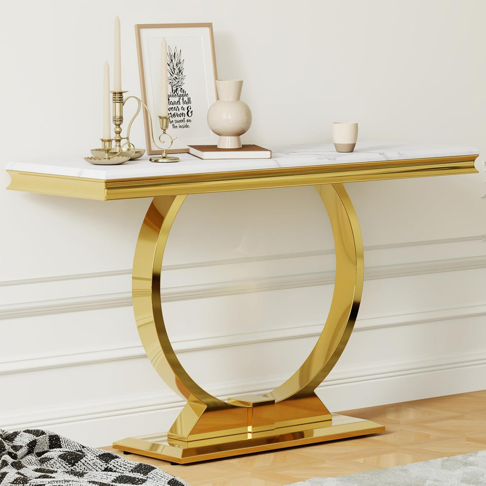 Gold console table with decorative items against a white wall