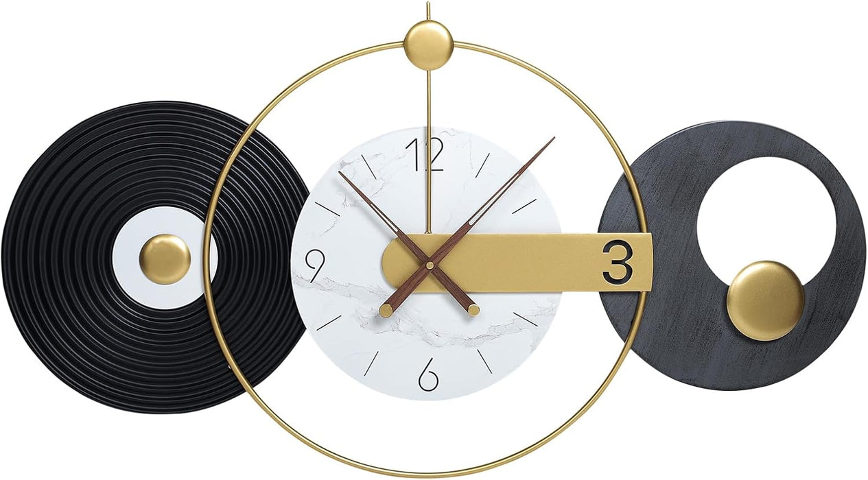 Modern wall clock with gold and black design on a white background
