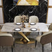 Dining table set with marble top and gold base in a modern room.