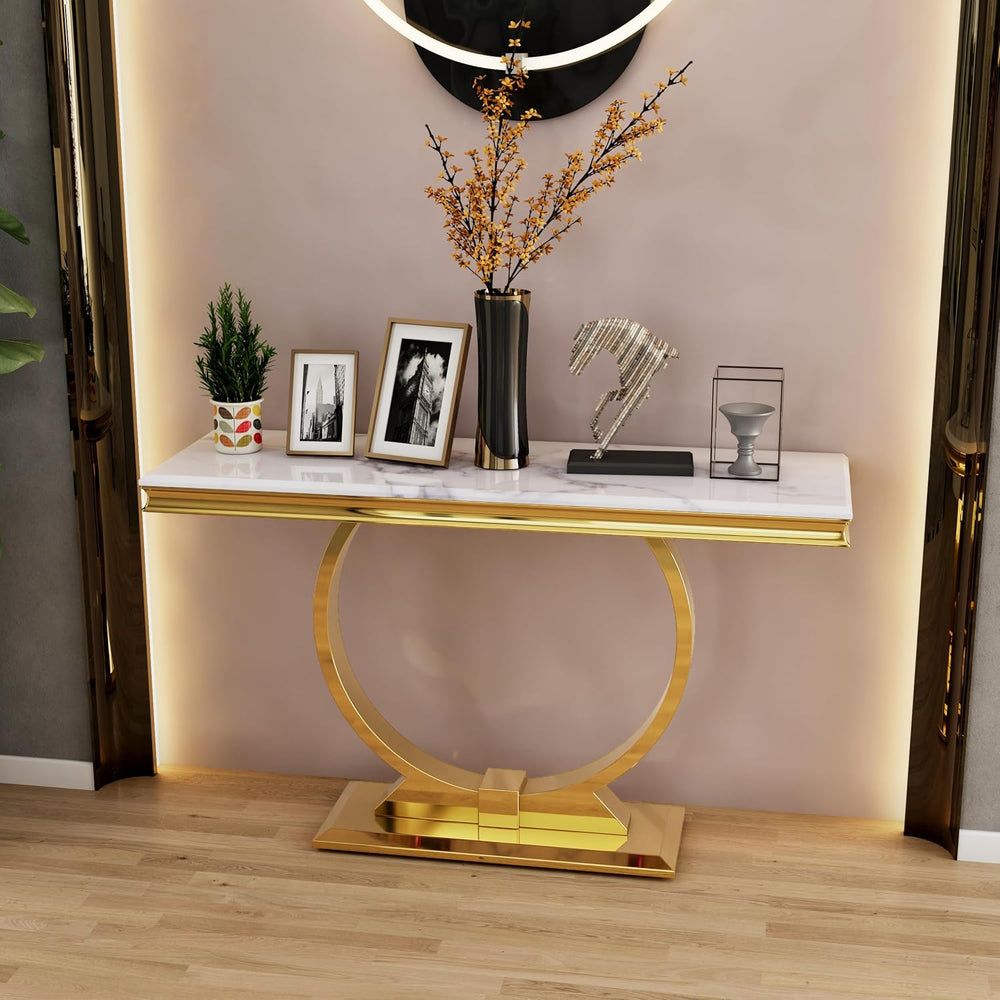 Decorative console table with gold base and marble top in a room setting.