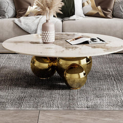 Modern coffee table with gold base and marble top in a living room setting