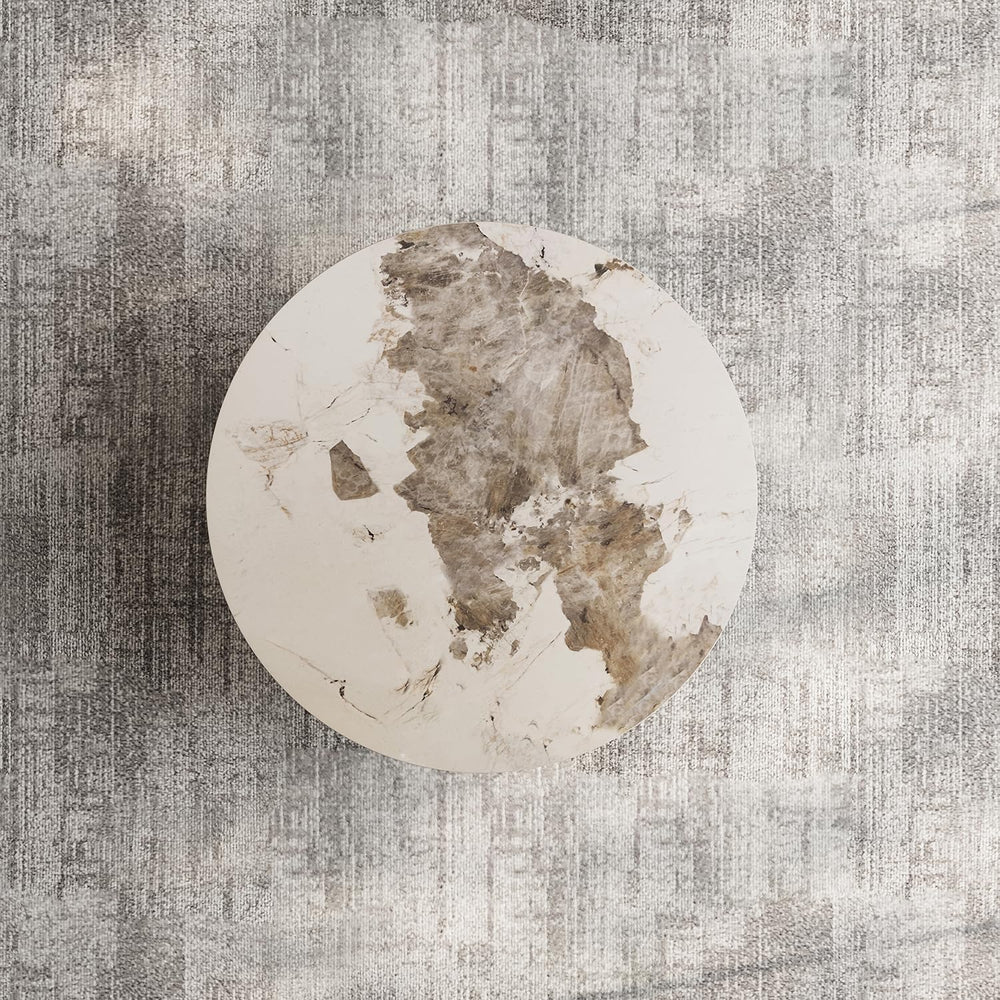 Round stone with a textured surface on a gray textured background