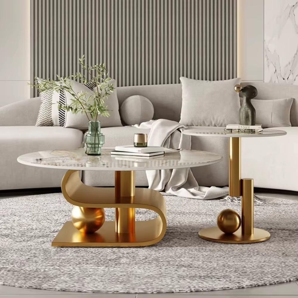 Modern living room with a gray sofa, marble coffee table, and gold side table.