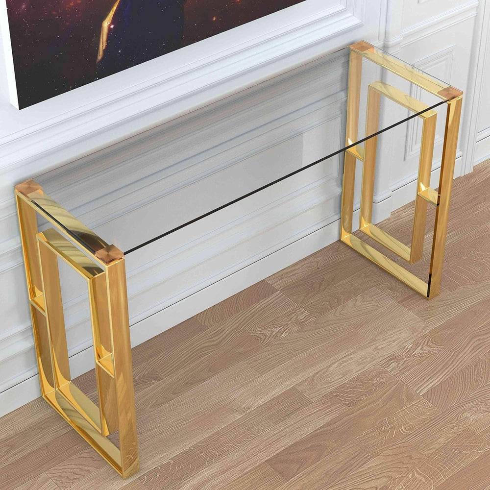 Glass console table with gold frame in front of a television