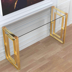 Glass console table with gold frame in front of a television