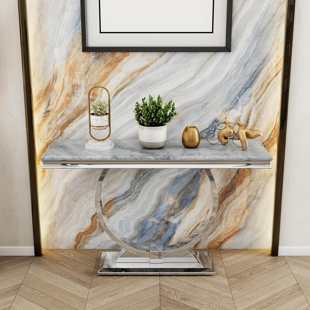 Decorative console table with marble finish against a marble wall.