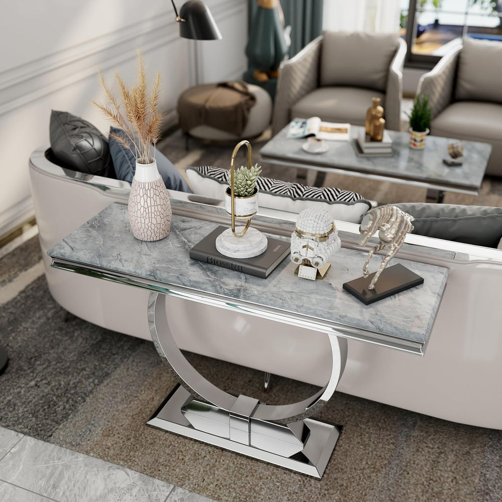 Modern living room with a decorative console table featuring marble surface and chrome base.