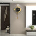 Modern wall clock with gold accents on a gray wall in a stylish interior setting.