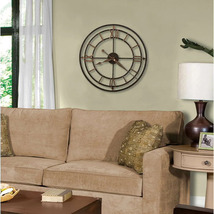 Living room with beige sofa, decorative clock, and lamp.