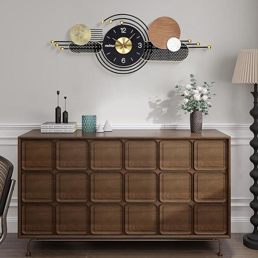 Wooden dresser with decorative wall clock in a room setting