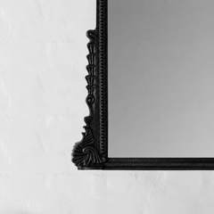 Black decorative mirror corner on a white wall