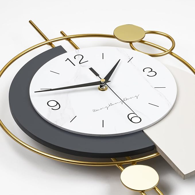 Modern wall clock with gold and gray design on a white background
