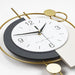 Modern wall clock with gold and gray design on a white background