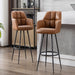 Two brown leather bar stools with black metal legs.