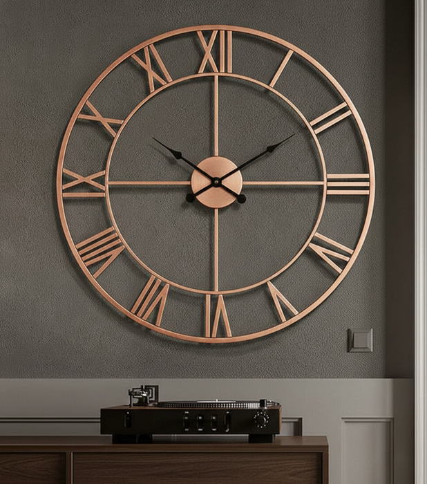 Large copper wall clock on a gray wall with a wooden cabinet below.