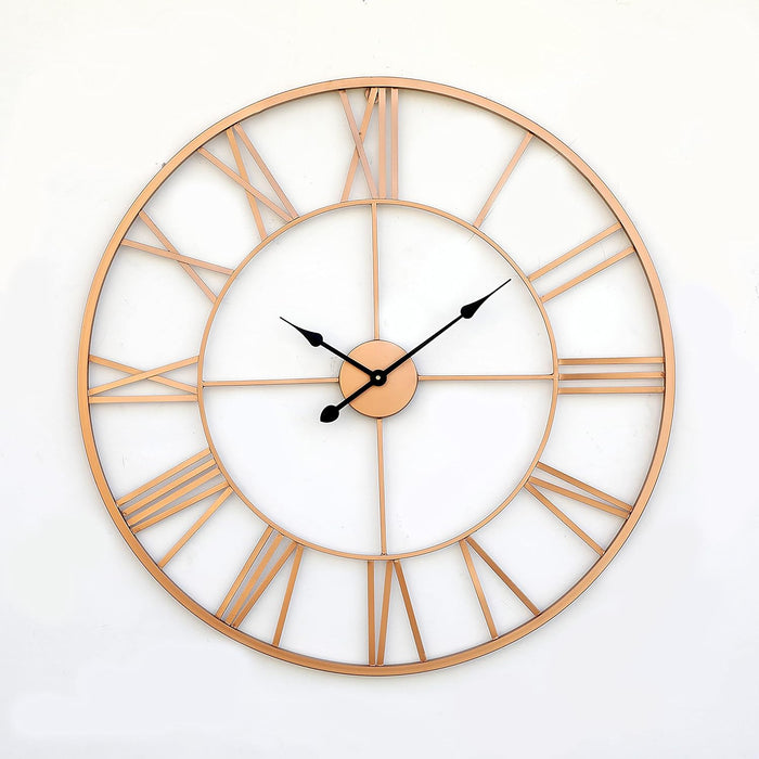 Large round wall clock with rose gold frame and Roman numeral markers on a white background