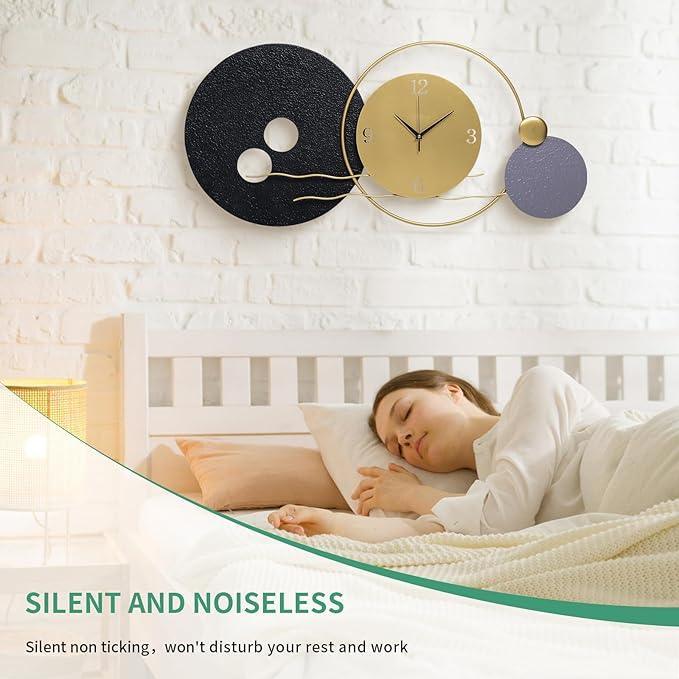 Woman sleeping in a crib with a modern wall clock above her.