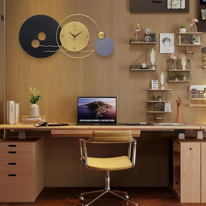 Wooden office desk with a laptop, chair, and decorative items on a wooden wall.