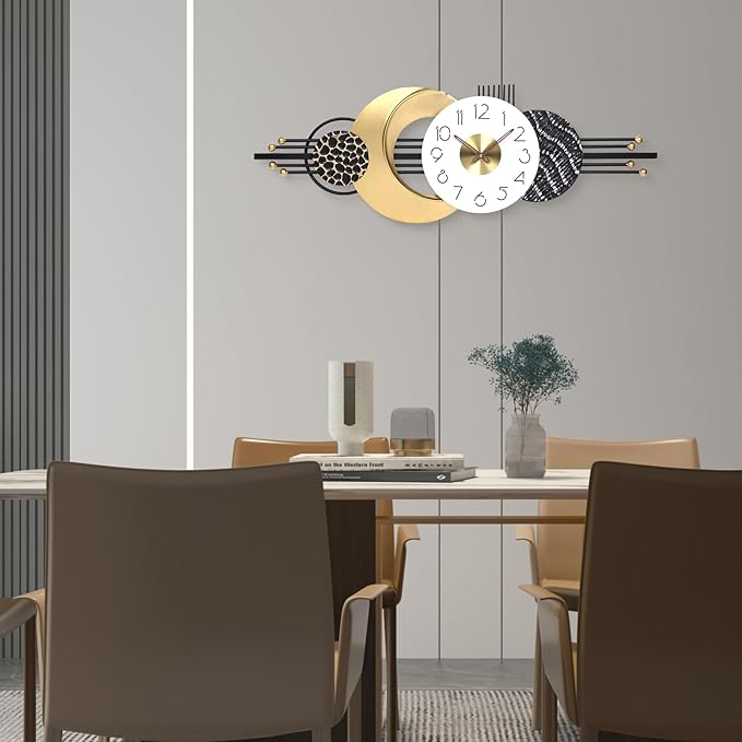 Modern wall clock with decorative design in a room with a table and chairs.