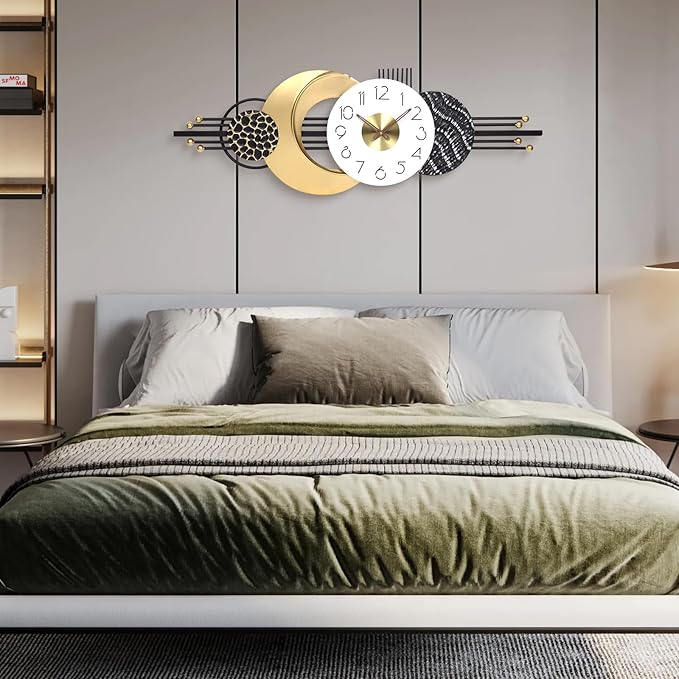 Decorative wall clock with moon and star design above a bed in a bedroom.