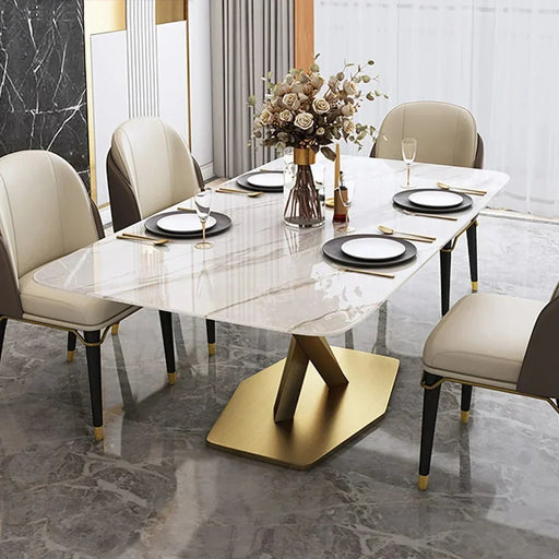 Dining table set with chairs and a decorative flower arrangement in a modern room.