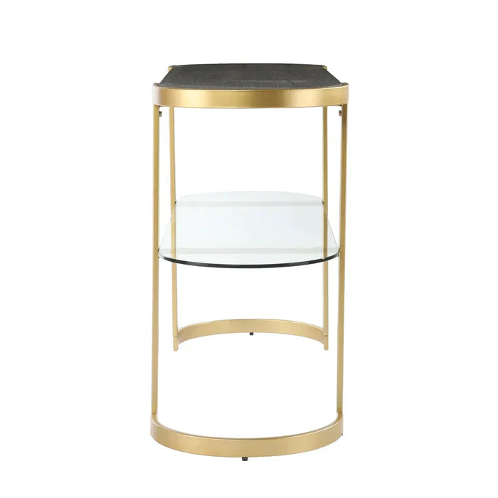 Gold console table with black top and glass shelves on a white background