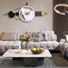 Modern living room with a gray sofa, coffee table, and decorative wall clock.