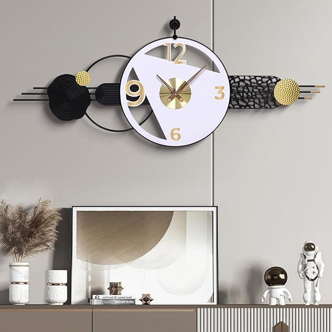 Decorative wall clock with black, gold, and white design on a gray wall.