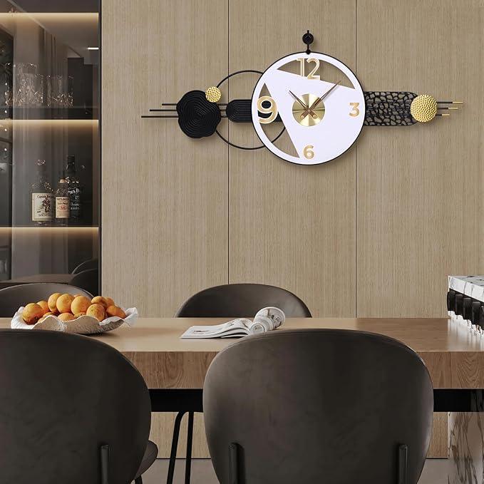 Modern wall clock with decorative elements on a wall above a dining table.