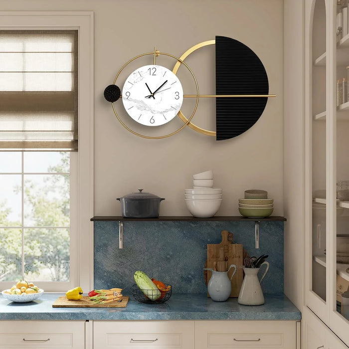 Modern wall clock with black and gold design in a kitchen setting