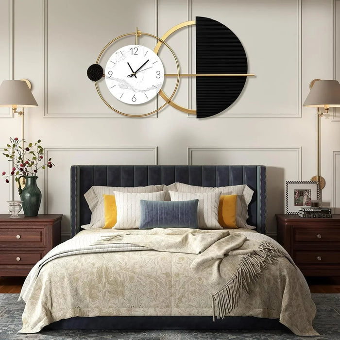 Modern bedroom with a decorative wall clock, bed, and side tables.