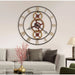 Large decorative wall clock with gear design in a living room setting.