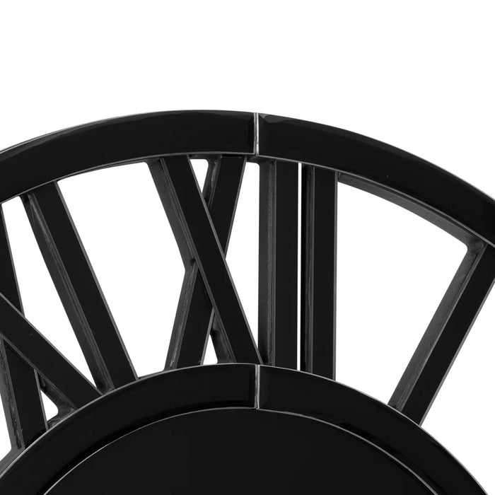Close-up of a black metal wheel with spokes on a white background