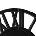Close-up of a black metal wheel with spokes on a white background