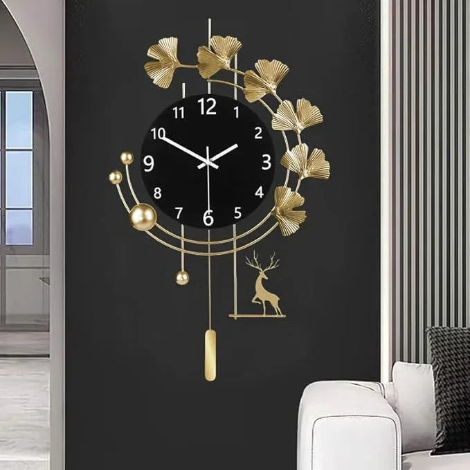 Decorative wall clock with gold leaves and deer design on a black background