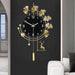 Decorative wall clock with gold leaves and deer design on a black background