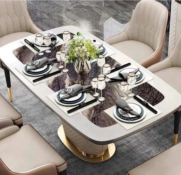 Dining table set with plates, glasses, and silverware on a marble-patterned tablecloth.