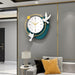 Decorative wall clock with bird designs on a gray wall above a sofa.