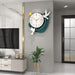 Decorative wall clock with bird designs on a modern living room wall.
