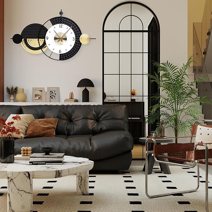 Modern living room with a black leather sofa, marble coffee table, and decorative wall clock.