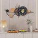 Decorative wall clock with wooden and metallic design in a room setting.