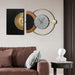 Decorative wall clock with artistic design on a wall above a brown sofa.