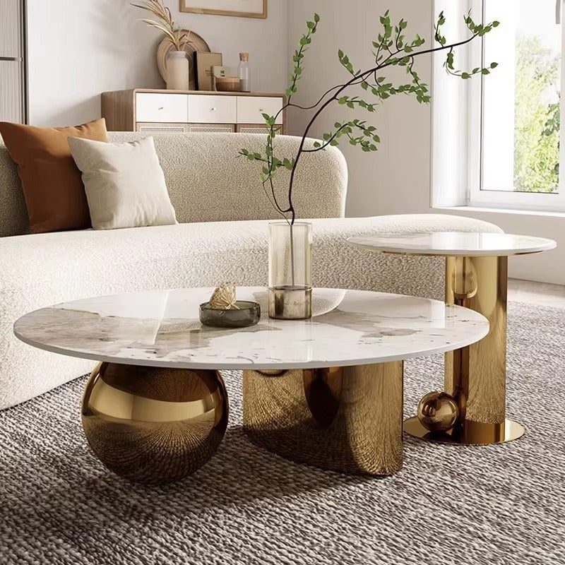 Modern coffee table with marble top and gold legs in a living room setting