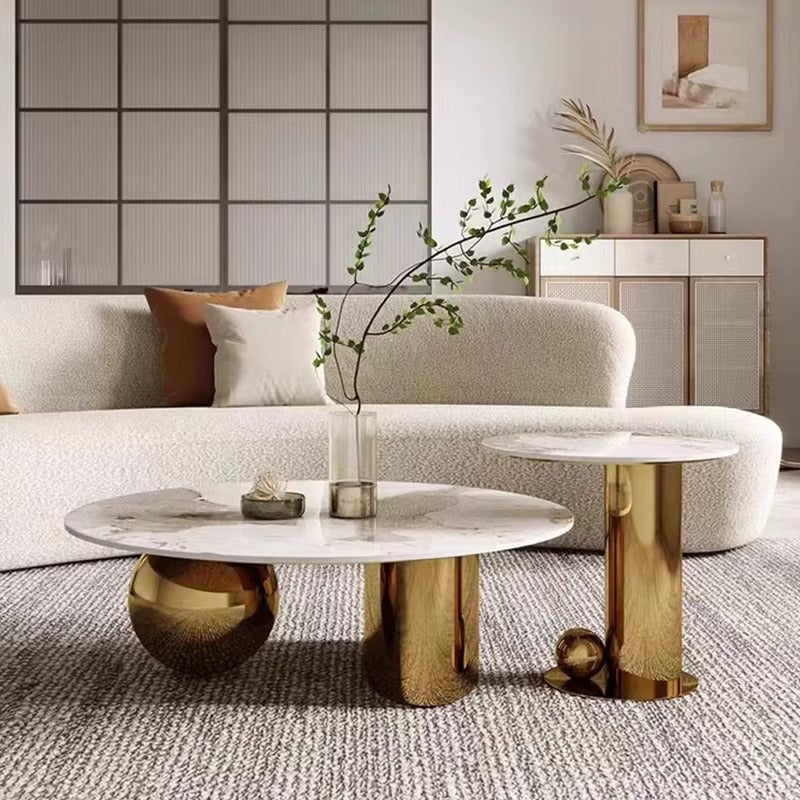 Modern living room with a marble coffee table and gold side table.