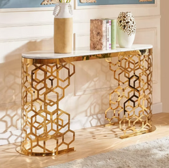 Gold console table with geometric design in a room setting